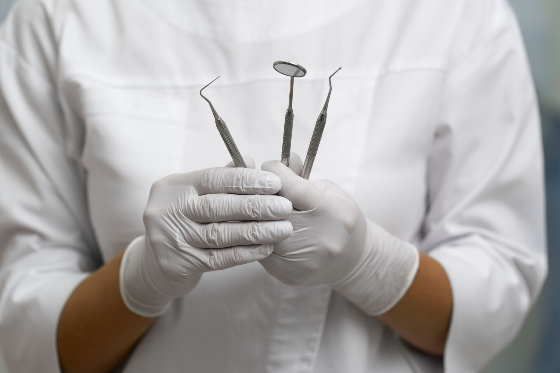 Close up pictire of dentists hands with dental medical tools