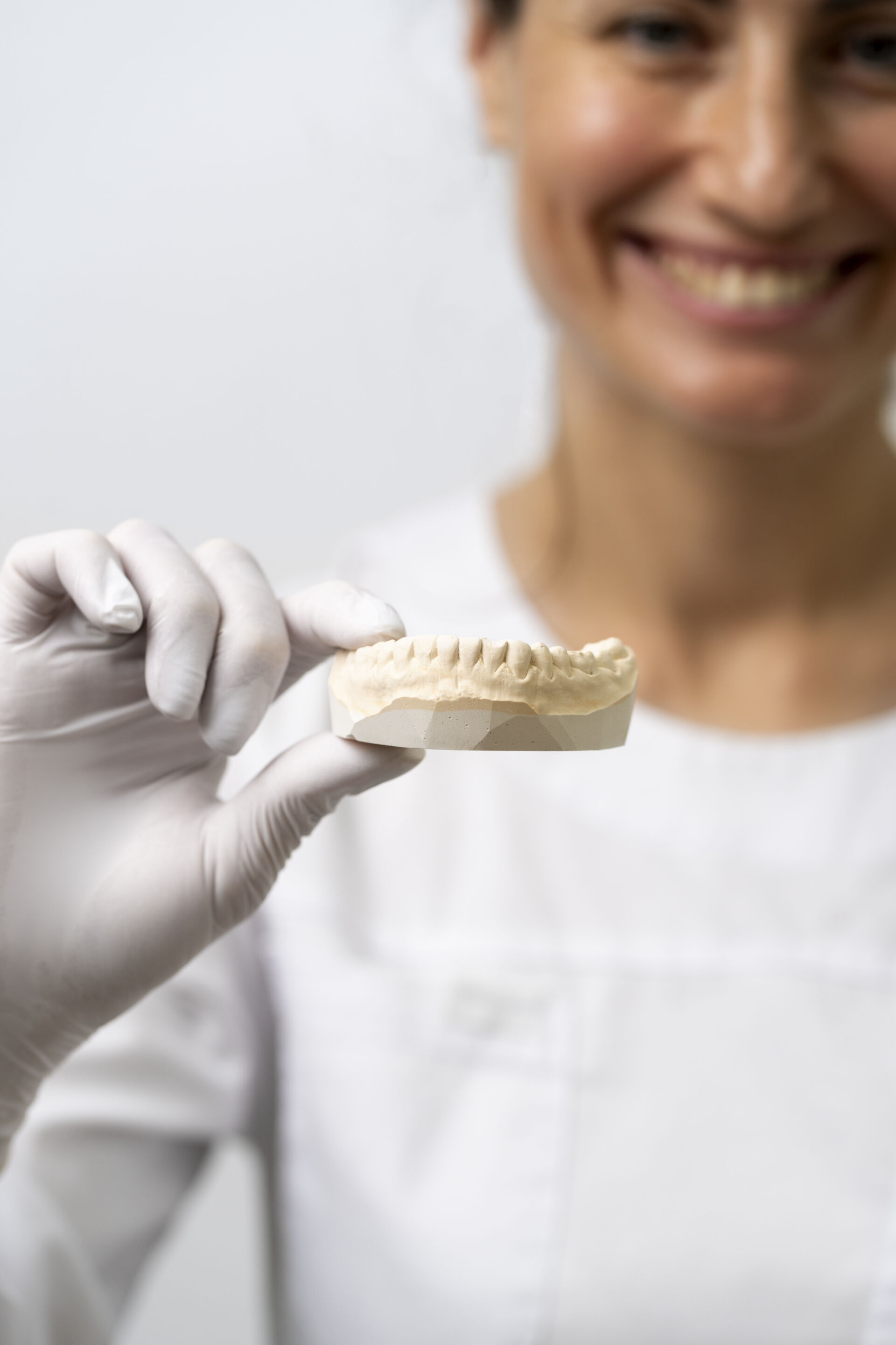Dentist holding a mold of patients teeth