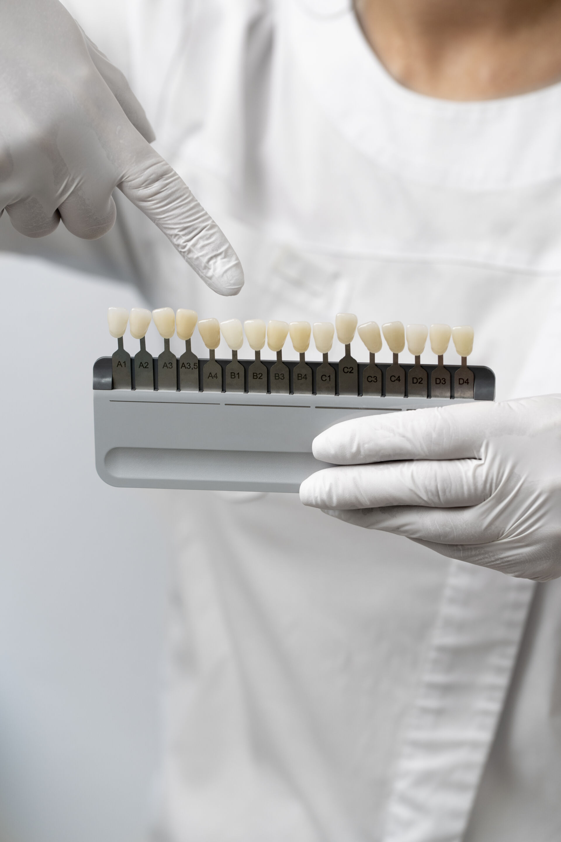 Dentist pointing at teeth colour option