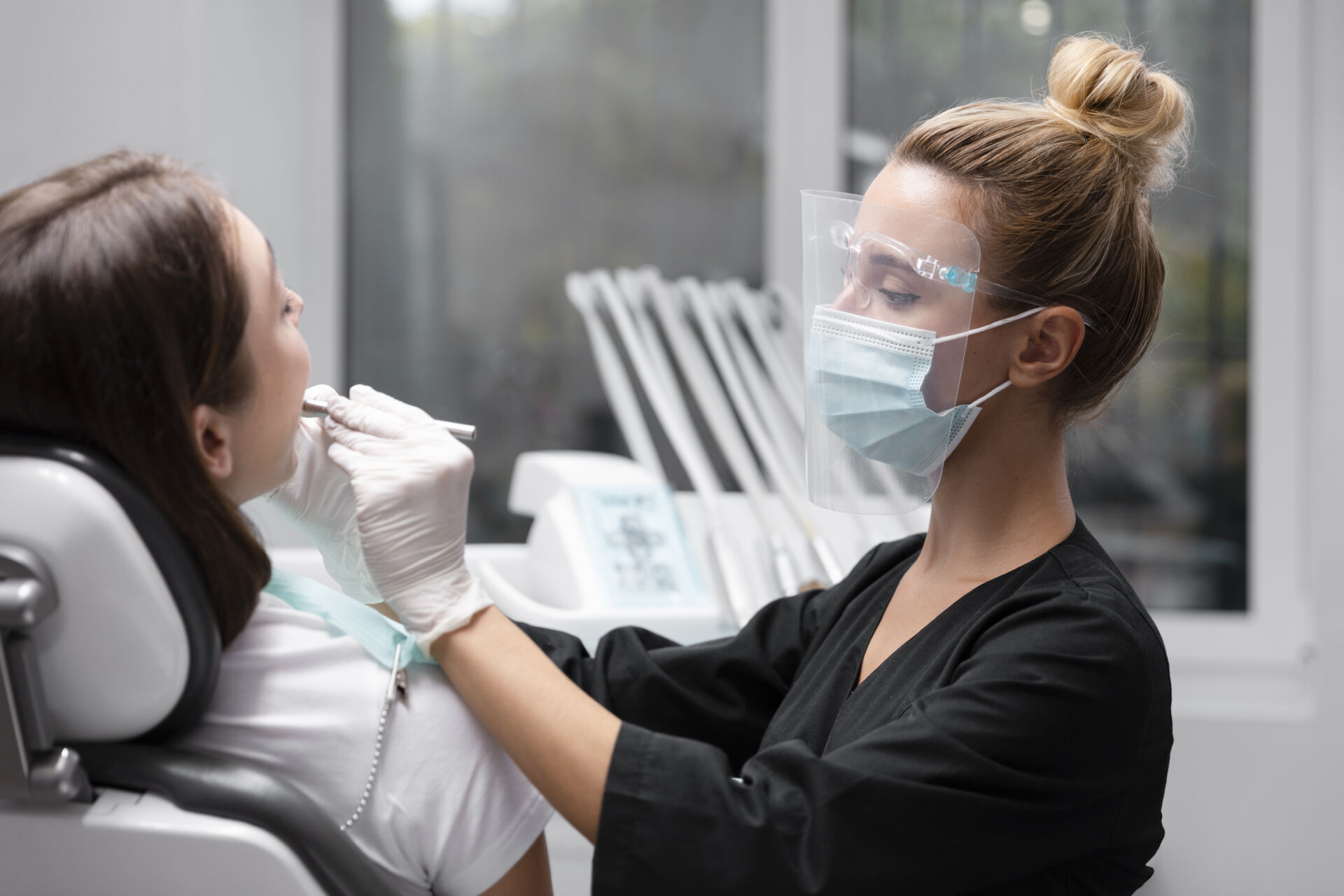 Patient First Dentist cleaning patients teeth
