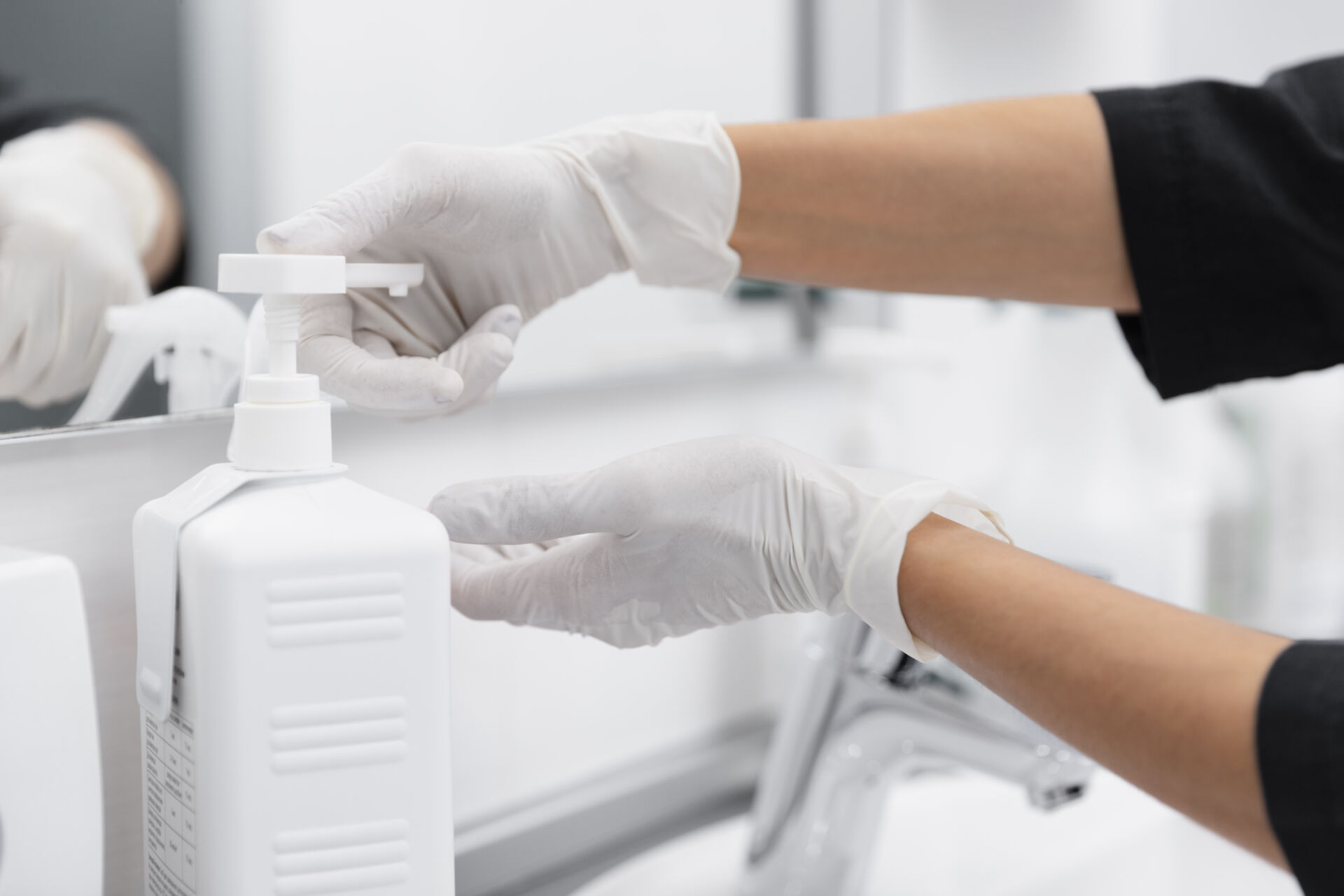 Dentist cleaning hands with disinfectant