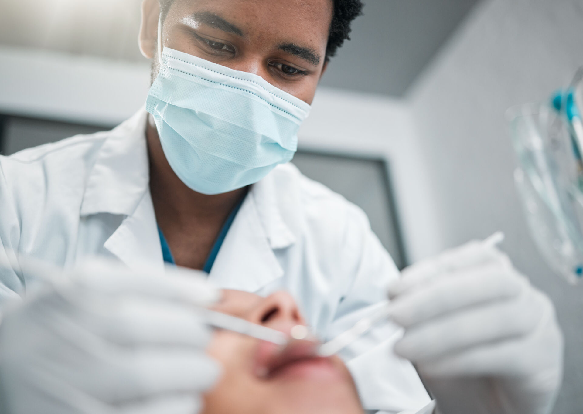 Patient First Dentist checking patient's teeth