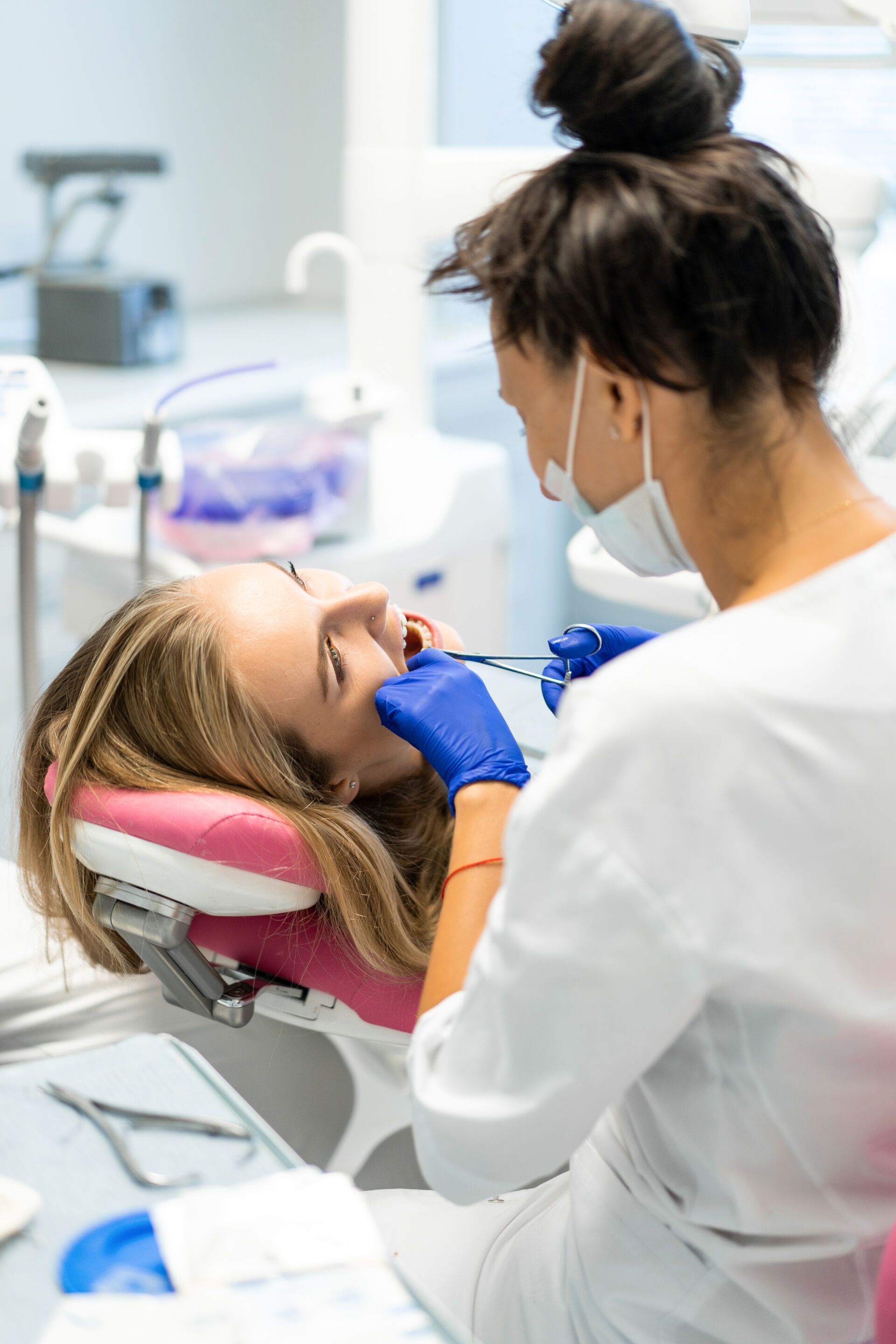 Patient First Dentist pulling out a patient's tooth