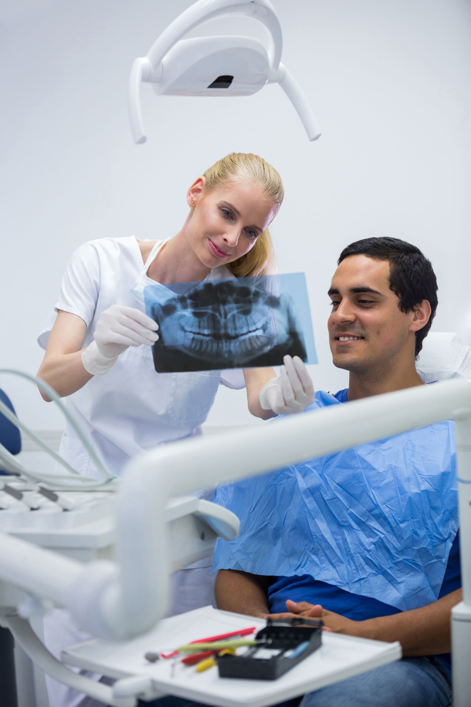 Patient First Dentist showing X-Ray of teeth to patient
