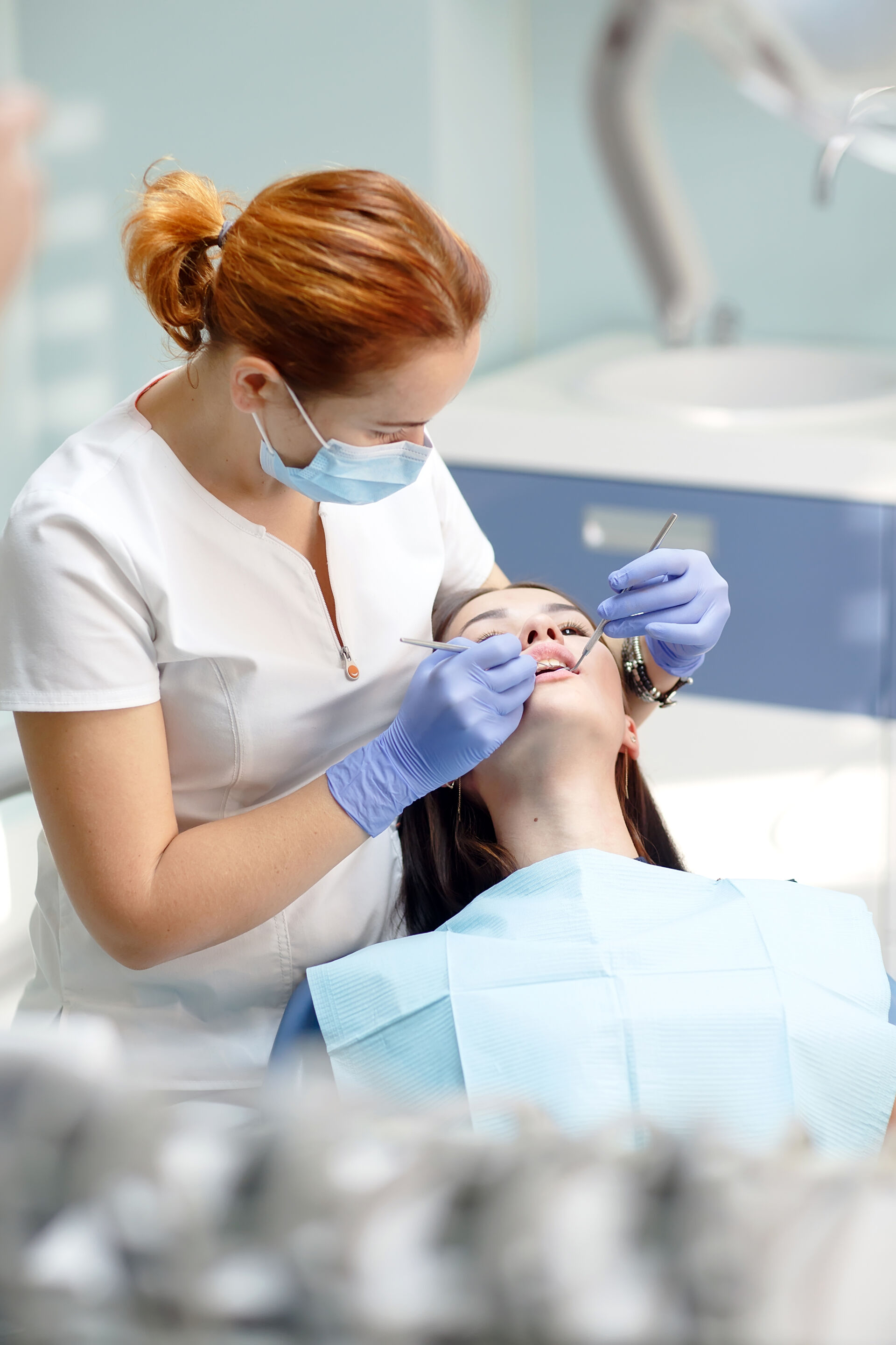Patient First Dentist checking young girls teeth