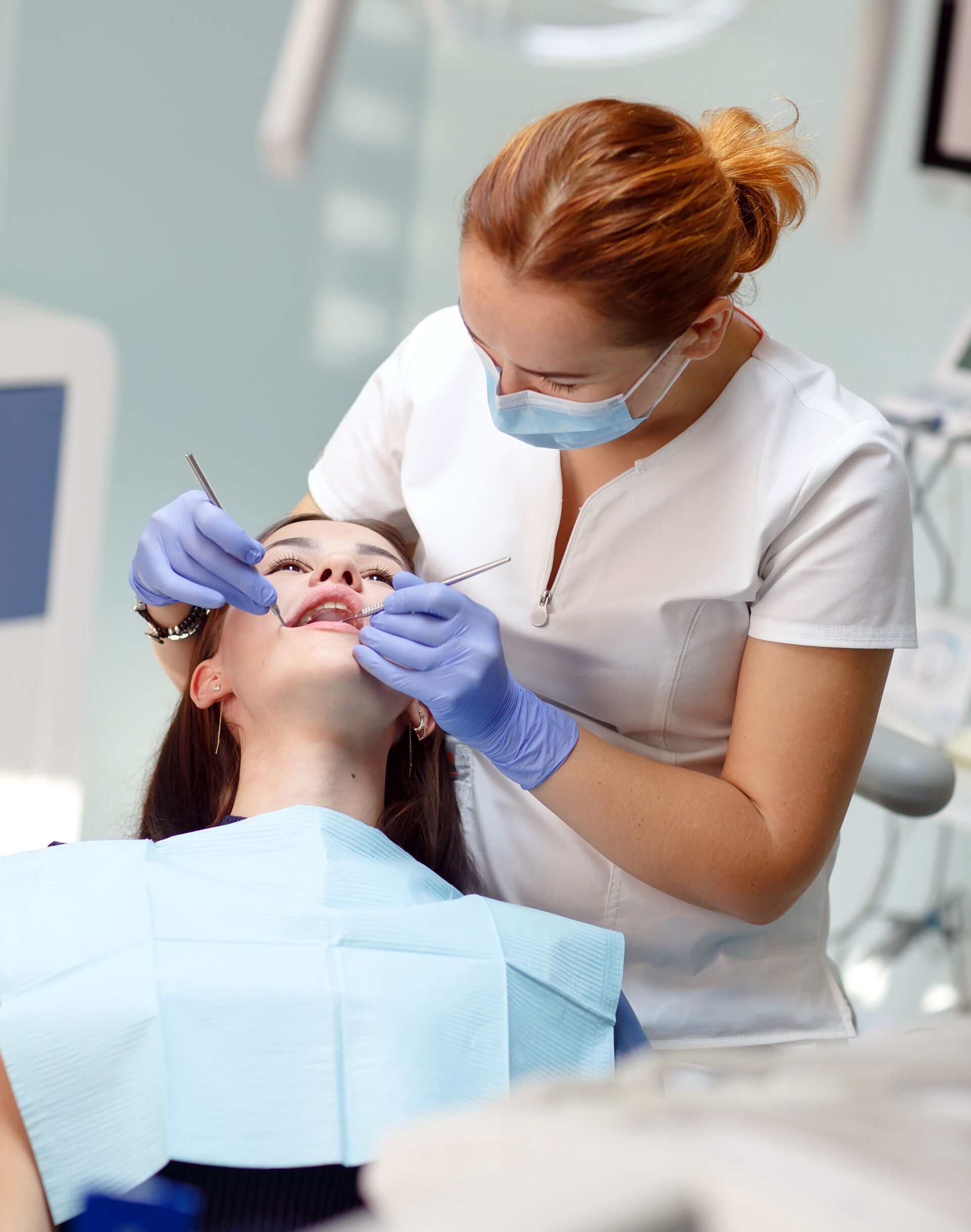 Patient First - Dentist performing check-up on young girl