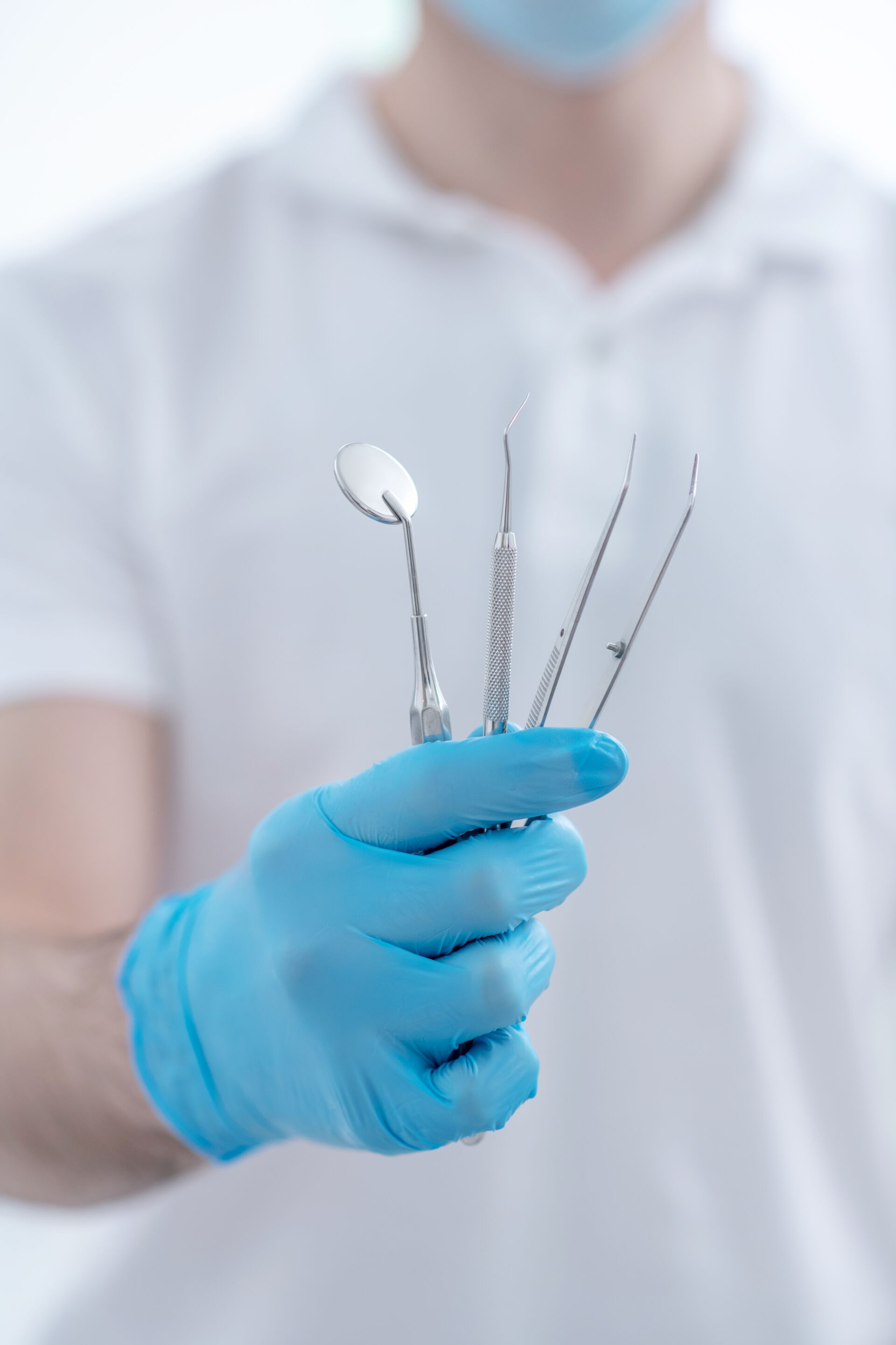 Close up pictire of dentists hands with dental medical tools