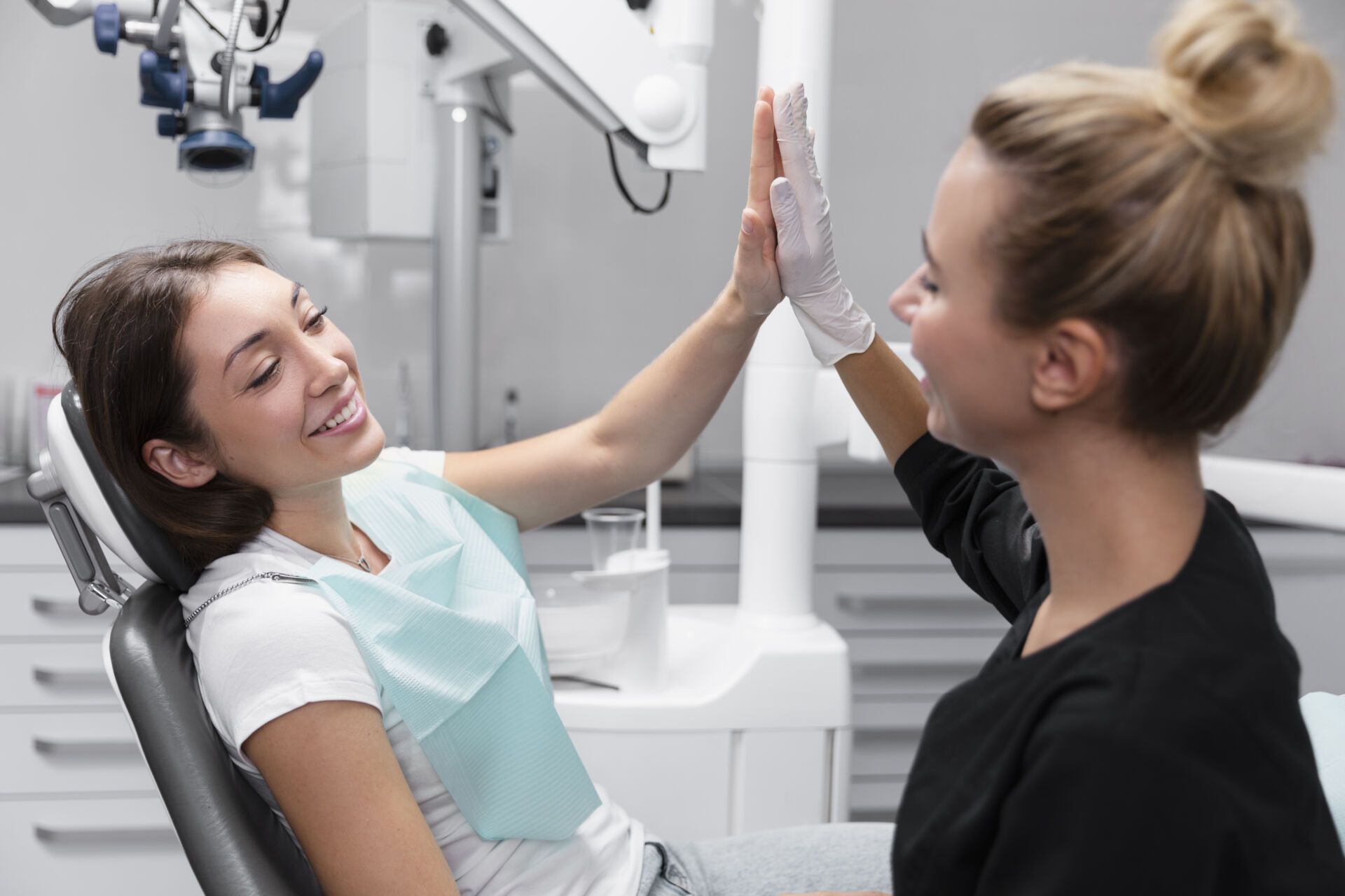 Patient high fiving Patient First dentist