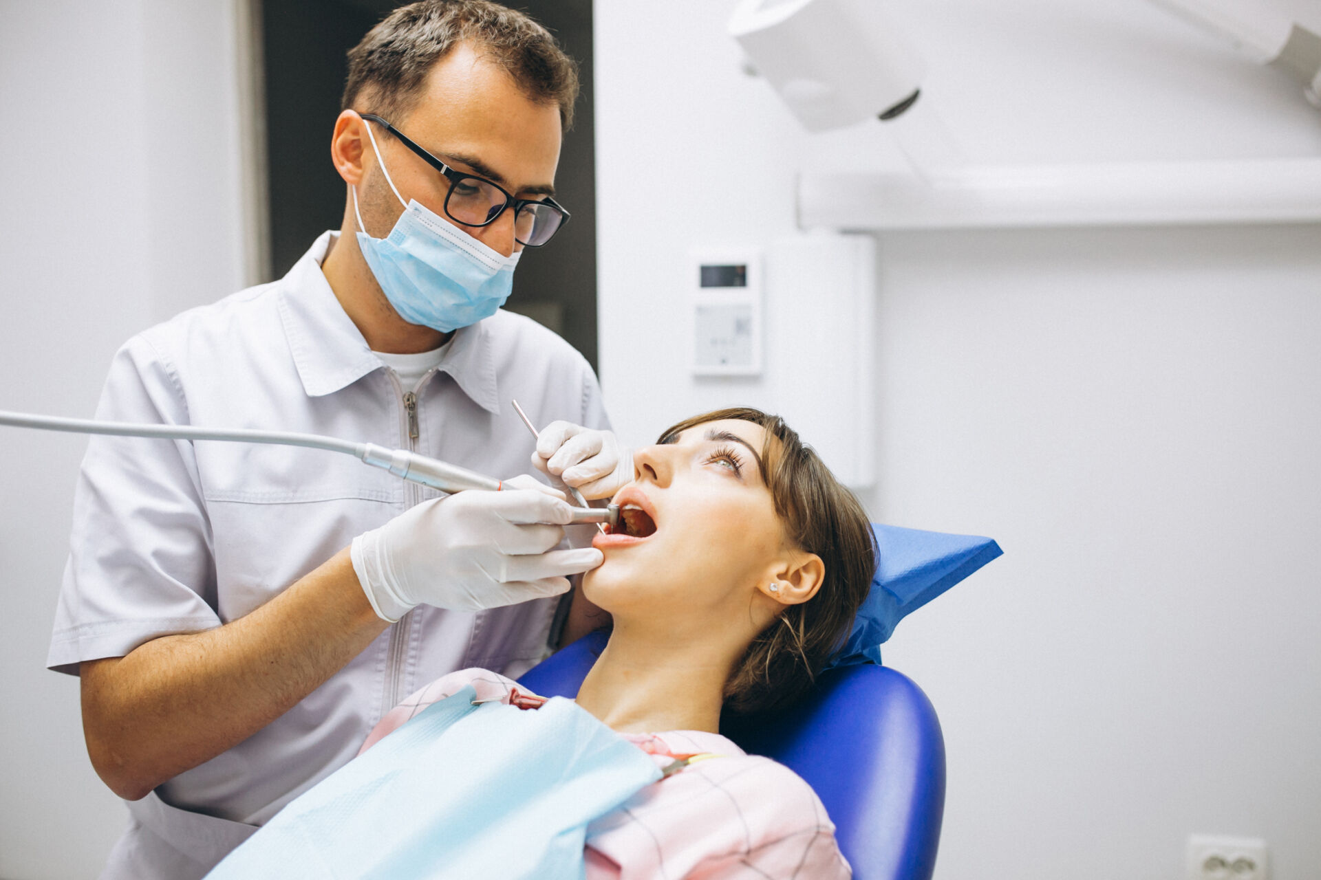 Patient First Dentist examining patient in clinic