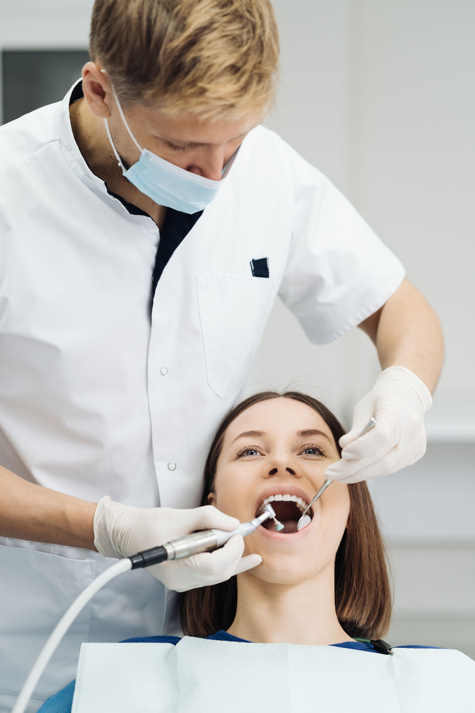 Patient First Dentist performing oral hygiene on patient