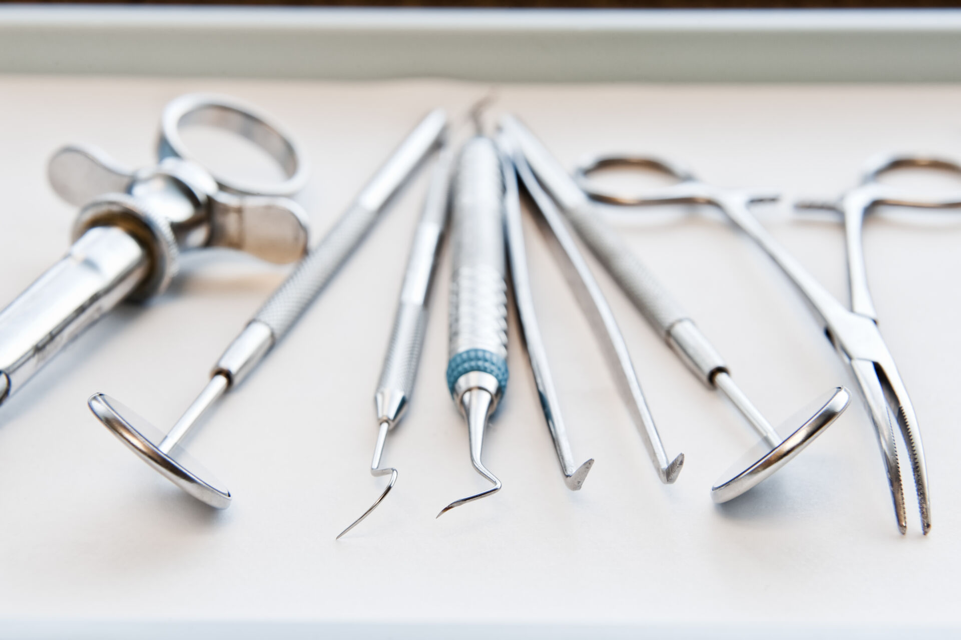Closeup of medical tools on a tray in a dental surgery.
